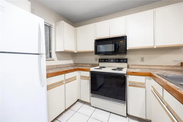a kitchen with cabinets stainless steel appliances and a sink
