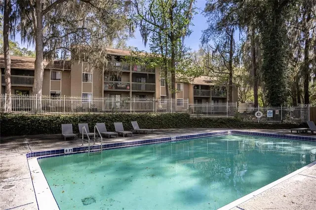 a house view with swimming pool and sitting space