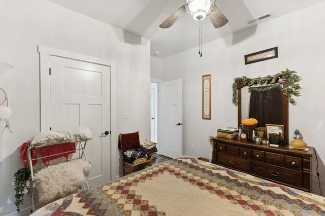 a bedroom with bed and cabinets