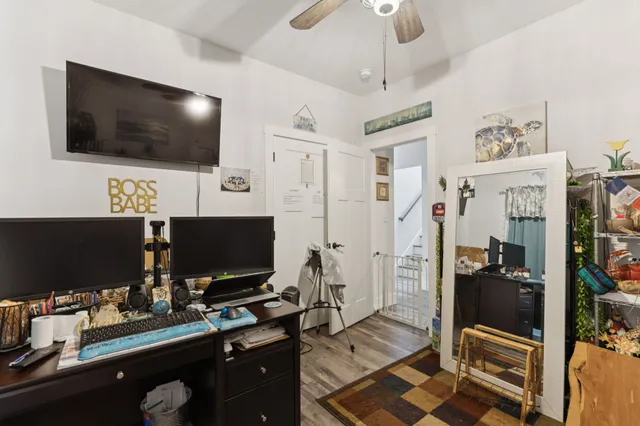 a desktop computer sitting on top of a work space with a flat screen tv