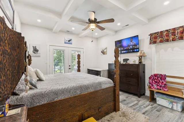 a bedroom with a bed and a chandelier