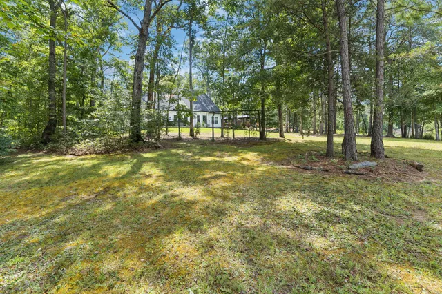 a view of a house with swimming pool and sitting area