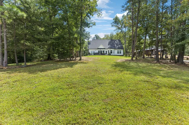 a front view of a house with sitting area and garden