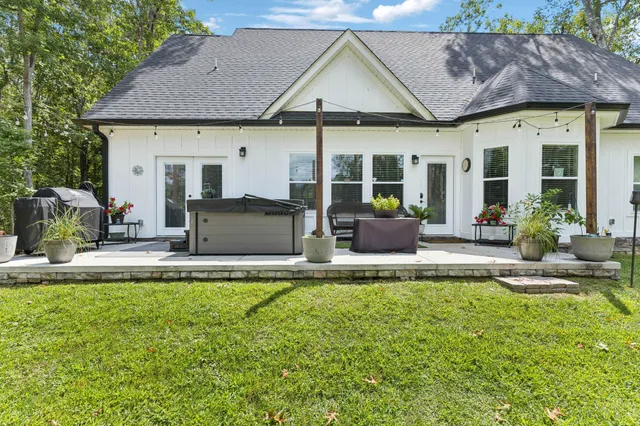 a view of a house with backyard and sitting area