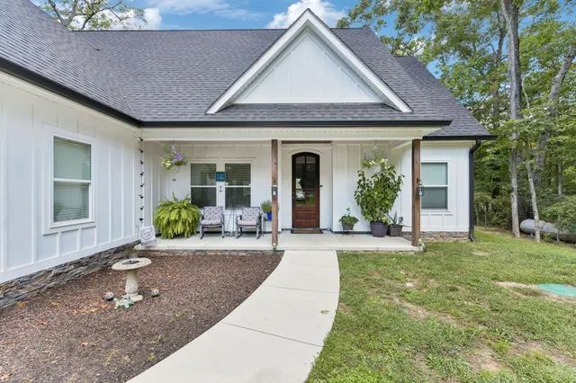 a front view of a house with garden