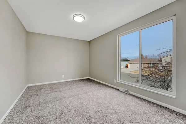 an empty room with a fireplace