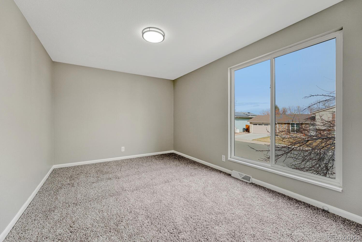 7121 Xavier Street Westminster, CO 80030 - Photo 12 of 23 an empty room with a fireplace