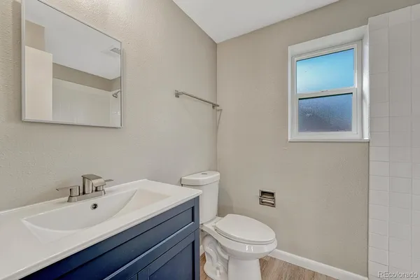 a bathroom with a sink a toilet and mirror