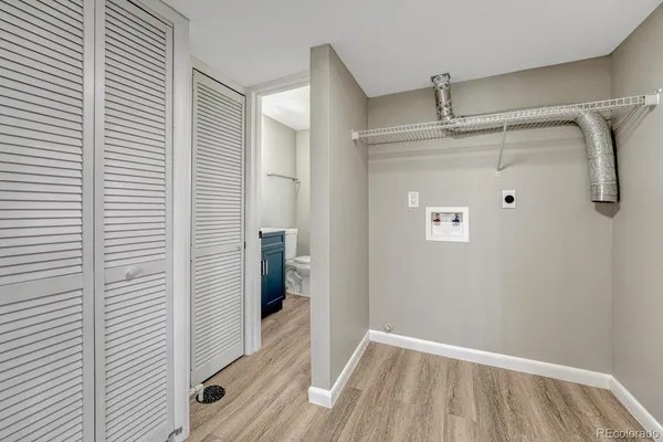 an empty room with windows and closet