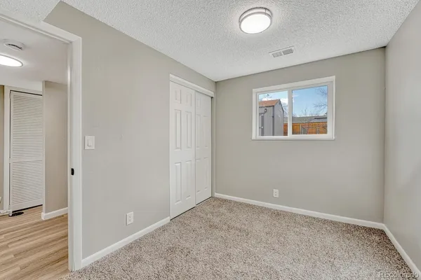 a view of a house with backyard and a tree