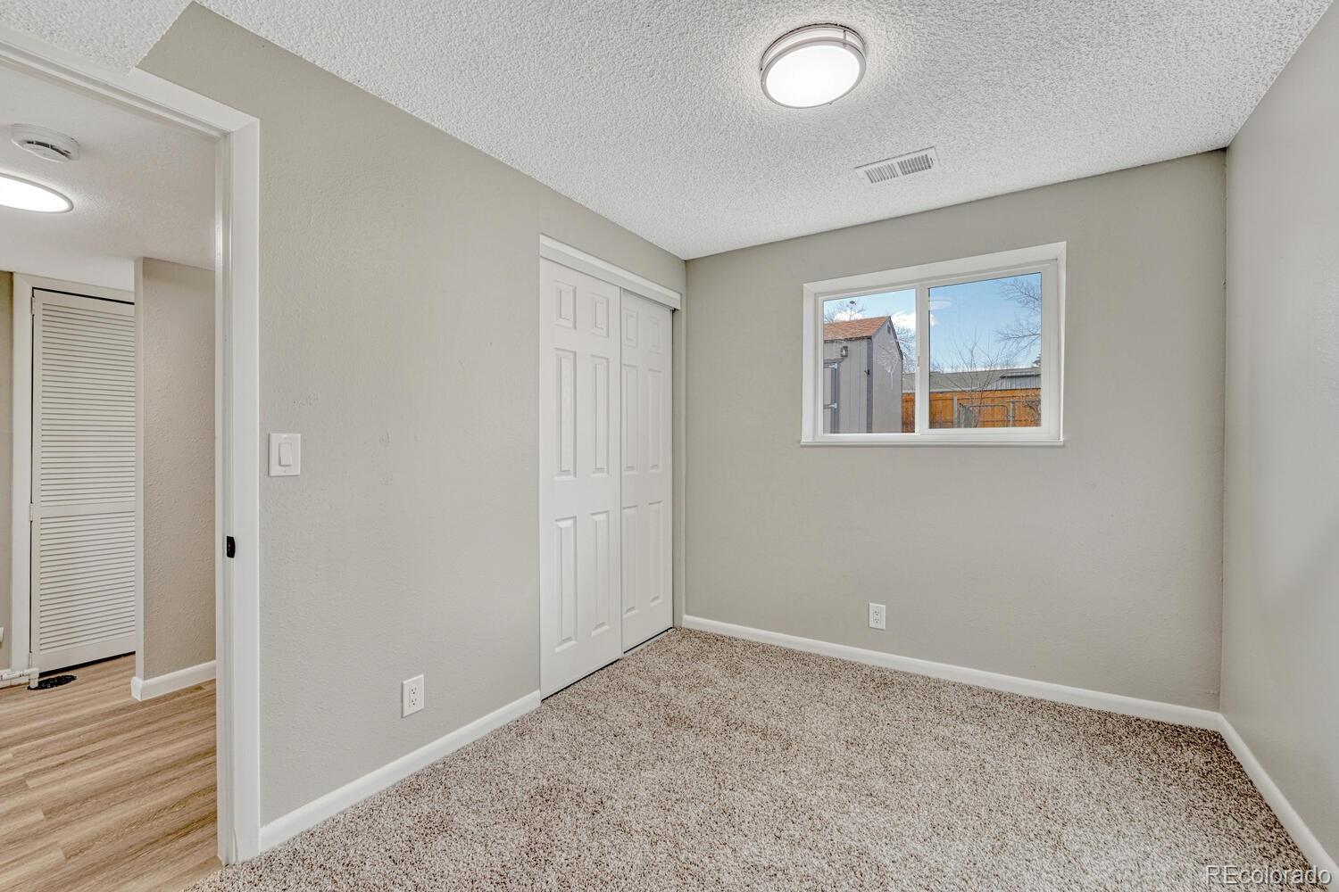 7121 Xavier Street Westminster, CO 80030 - Photo 16 of 23 an empty room with windows and closet