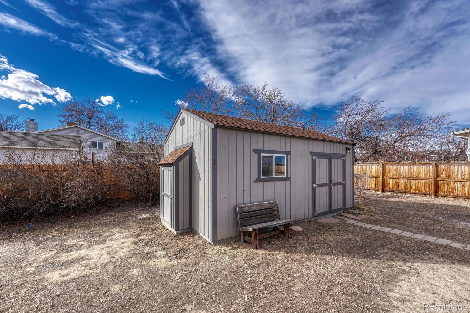 7121 Xavier Street Westminster, CO 80030 - Photo 17 of 23 a view of a house with backyard and a tree