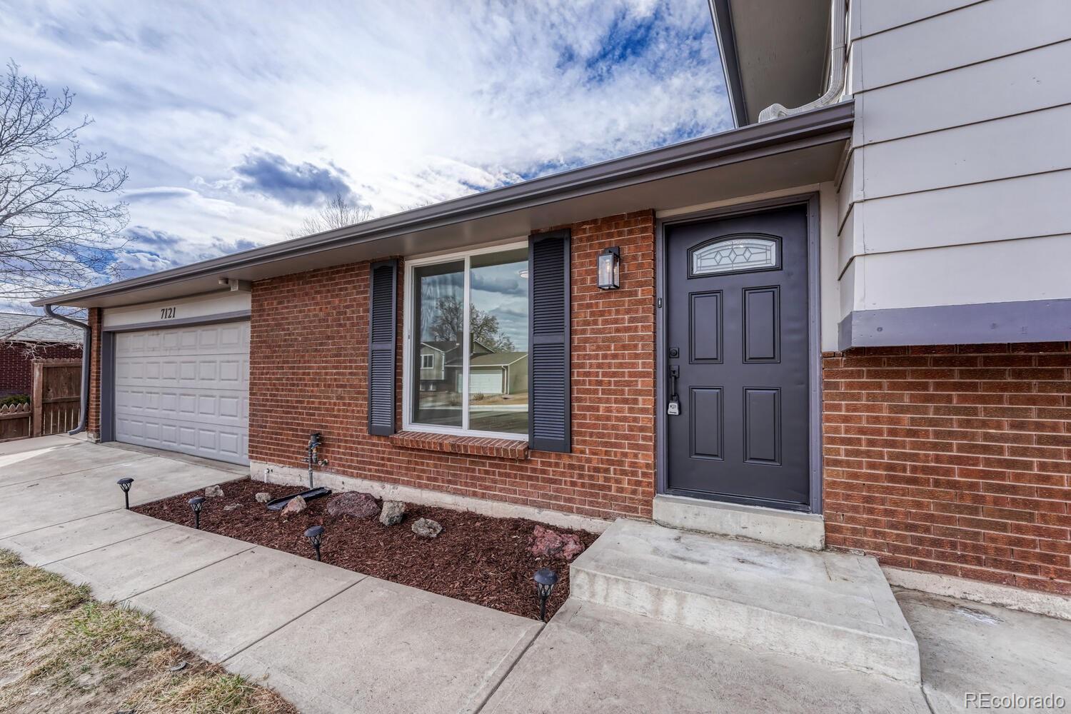 7121 Xavier Street Westminster, CO 80030 - Photo 2 of 23 a front view of a house