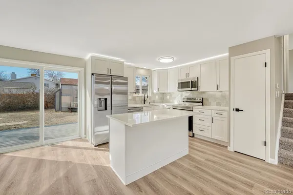 a kitchen with stainless steel appliances a refrigerator sink and cabinets