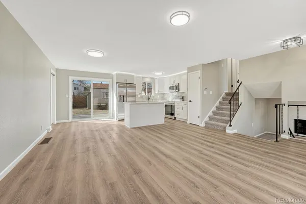 a view of a room with wooden floor and stairs