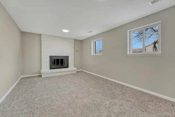 a view of an empty room with a fireplace