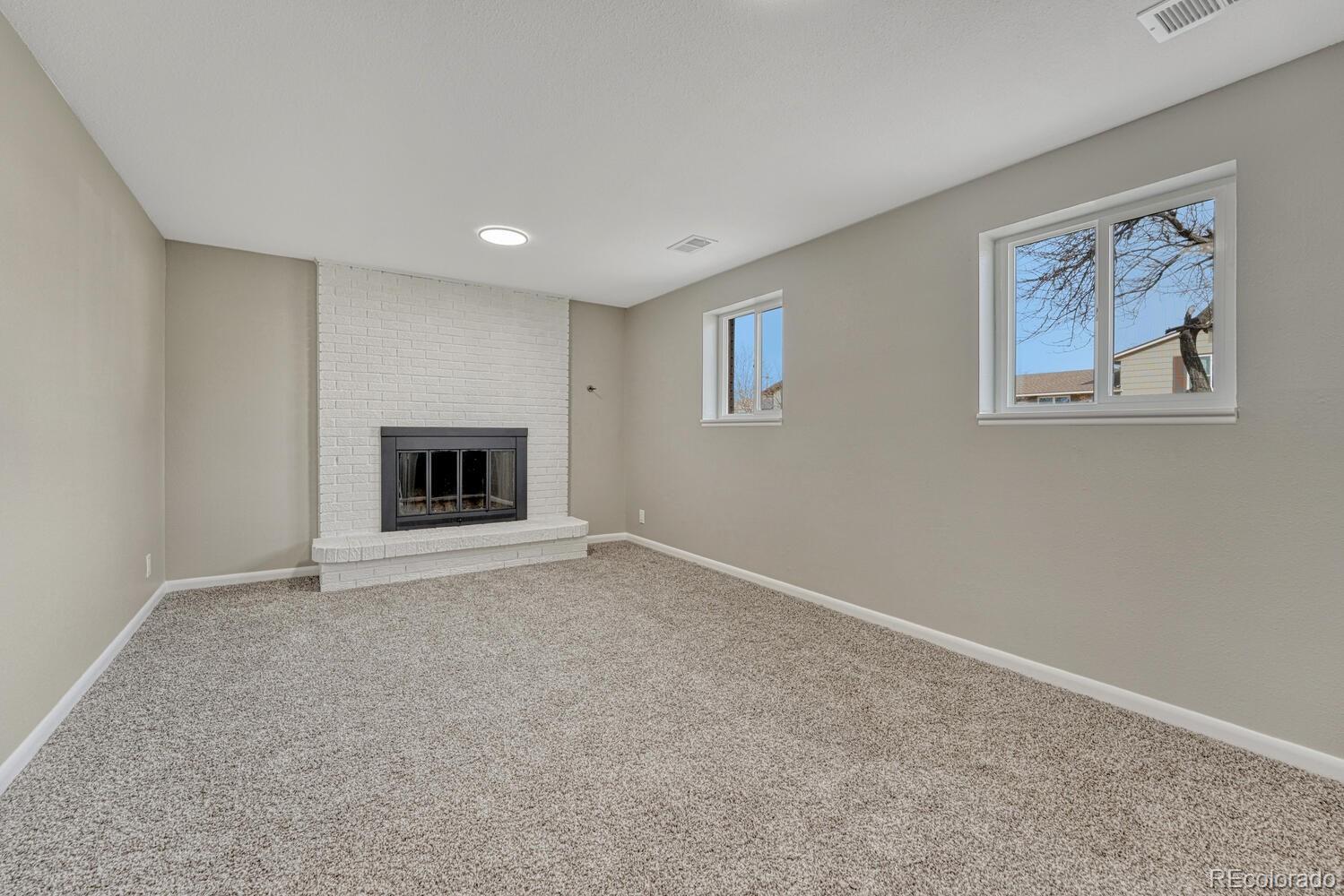 7121 Xavier Street Westminster, CO 80030 - Photo 7 of 23 a view of an empty room with a fireplace