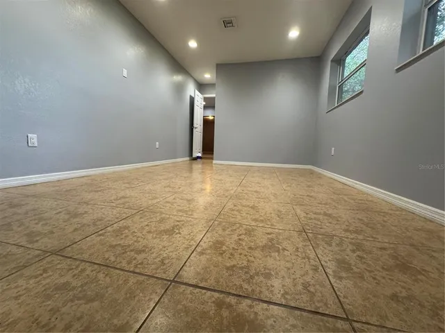 a bathroom with a granite countertop sink and a bathtub