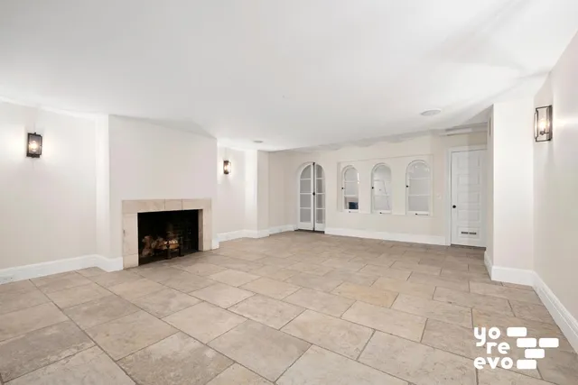 a view of empty room with fireplace