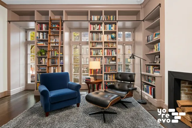 a living room with furniture potted plant and a fireplace