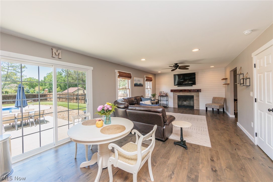 Dining space with ceiling fan and wood-type flooring