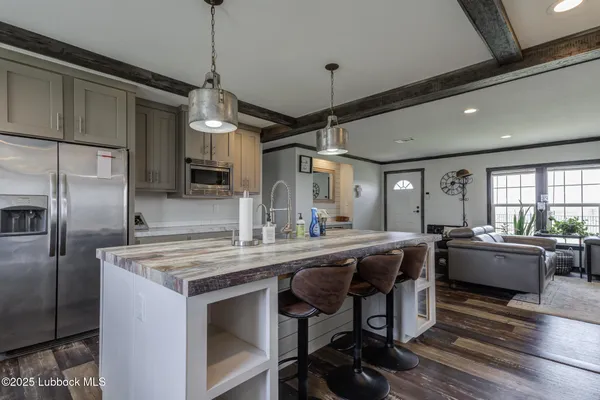 a kitchen with a stove a sink a window and wooden floor