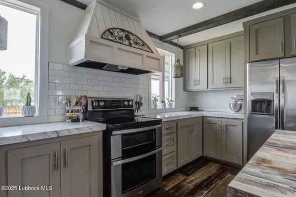 a kitchen with stainless steel appliances a stove a sink island and a refrigerator