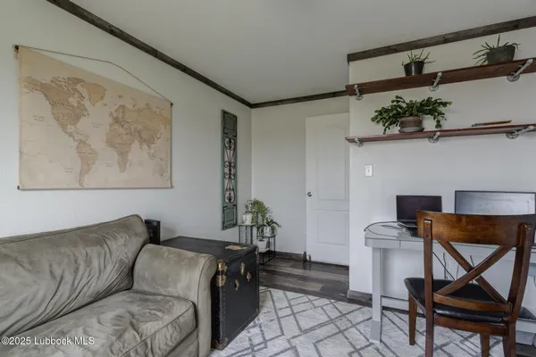 a bedroom with furniture and wooden floor