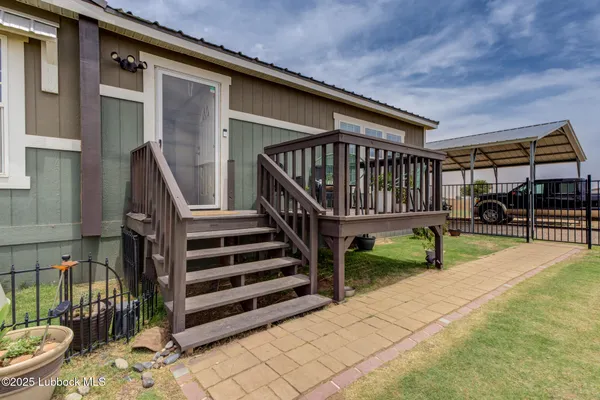 a view of house with deck outdoor seating and stairs
