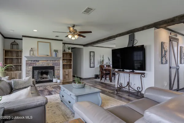 a living room with furniture ceiling fan and a window