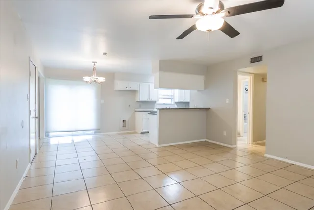 a view of a kitchen with marble kitchen and refrigerator
