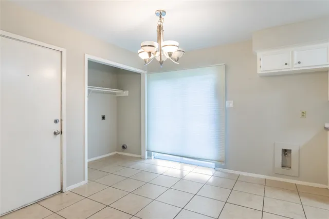 a kitchen with stainless steel appliances granite countertop a sink and dishwasher a stove top oven with white cabinets