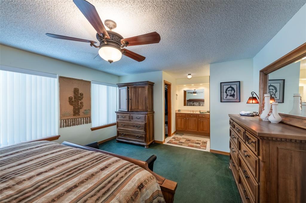1862 Wind Willow Road Belle Isle, FL 32809 - Photo 12 of 42 a bedroom with a bed and a chandelier