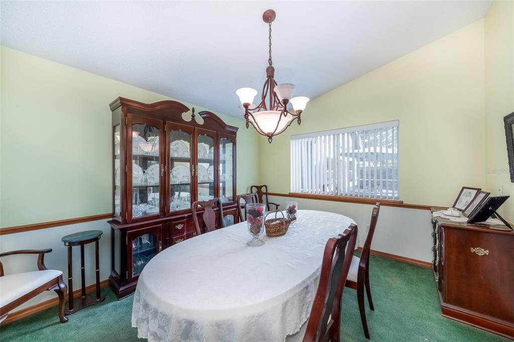 1862 Wind Willow Road Belle Isle, FL 32809 - Photo 16 of 42 a view of a dining room with furniture a chandelier and wooden floor