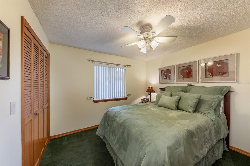 1862 Wind Willow Road Belle Isle, FL 32809 - Photo 18 of 42 a bed sitting in a bedroom next to a window