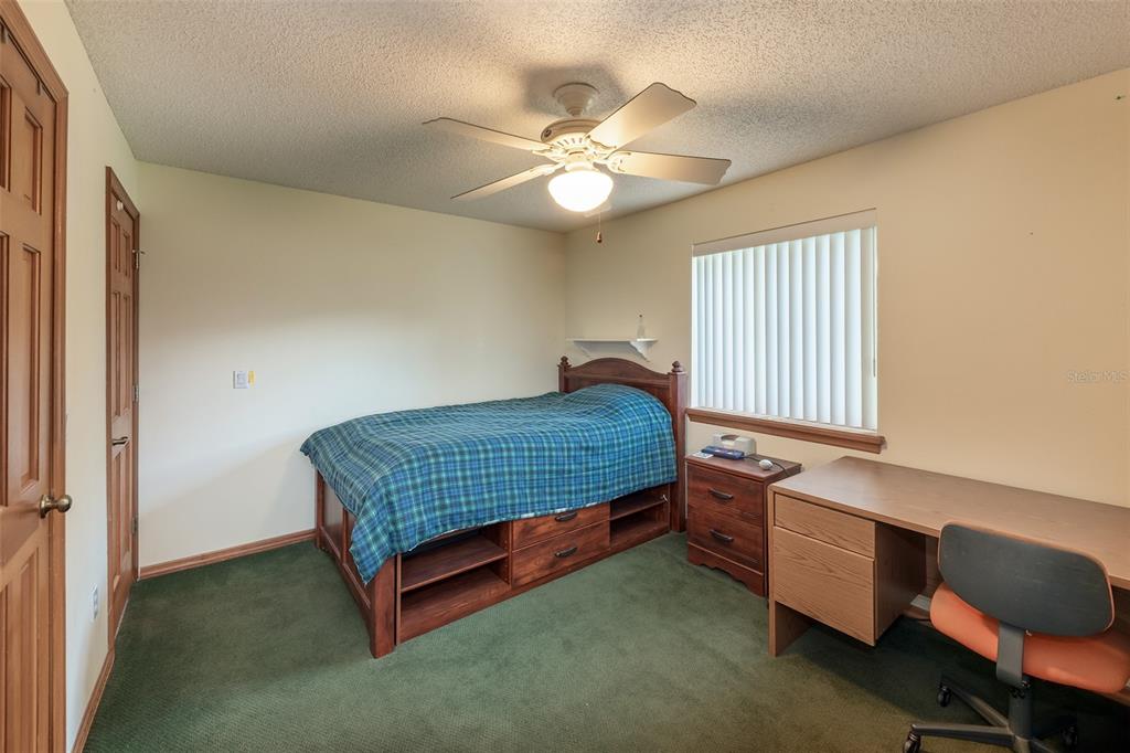 1862 Wind Willow Road Belle Isle, FL 32809 - Photo 20 of 42 a bedroom with a bed and a chandelier