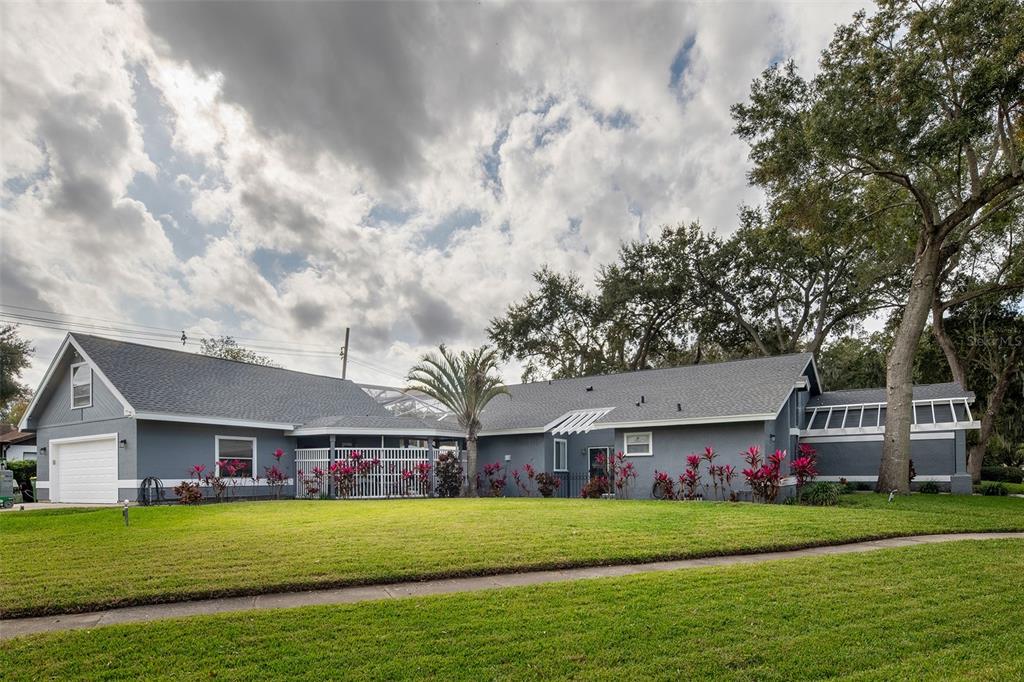 1862 Wind Willow Road Belle Isle, FL 32809 - Photo 3 of 42 a front view of a house with a garden and trees