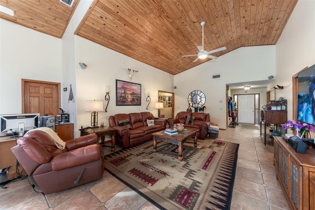 1862 Wind Willow Road Belle Isle, FL 32809 - Photo 6 of 42 a living room with furniture a chandelier