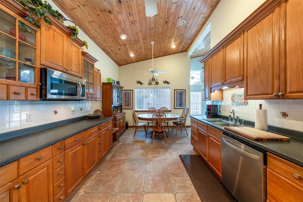 1862 Wind Willow Road Belle Isle, FL 32809 - Photo 10 of 42 a kitchen with stainless steel appliances granite countertop sink stove top oven and cabinets