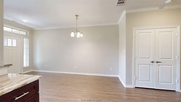 a view of a room with wooden floor cabinet and staircase