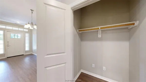 a view of a room with wooden floor