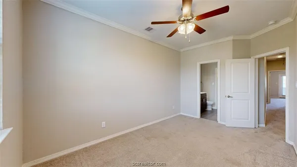 an empty room with closet and a chandelier fan