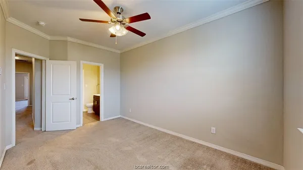 an empty room with closet and a ceiling fan