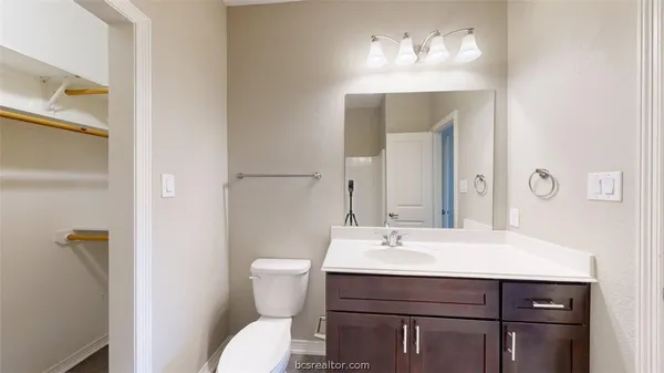 a bathroom with a sink toilet and a mirror