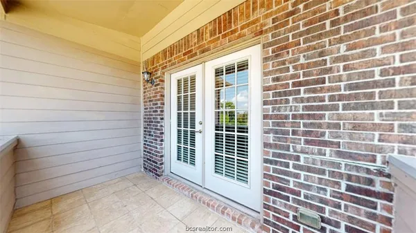 a front view of a house with plants
