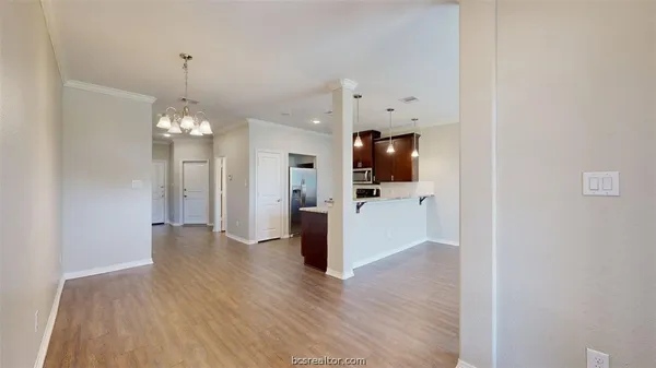 a view of a kitchen with a refrigerator a microwave and a sink