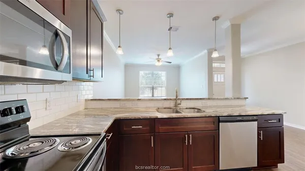 a kitchen with a sink stove and microwave