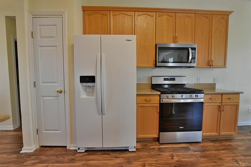 1132 Gower Street Fort Mill, SC 29708 - Photo 11 of 27 a kitchen with stainless steel appliances a stove a microwave and a refrigerator