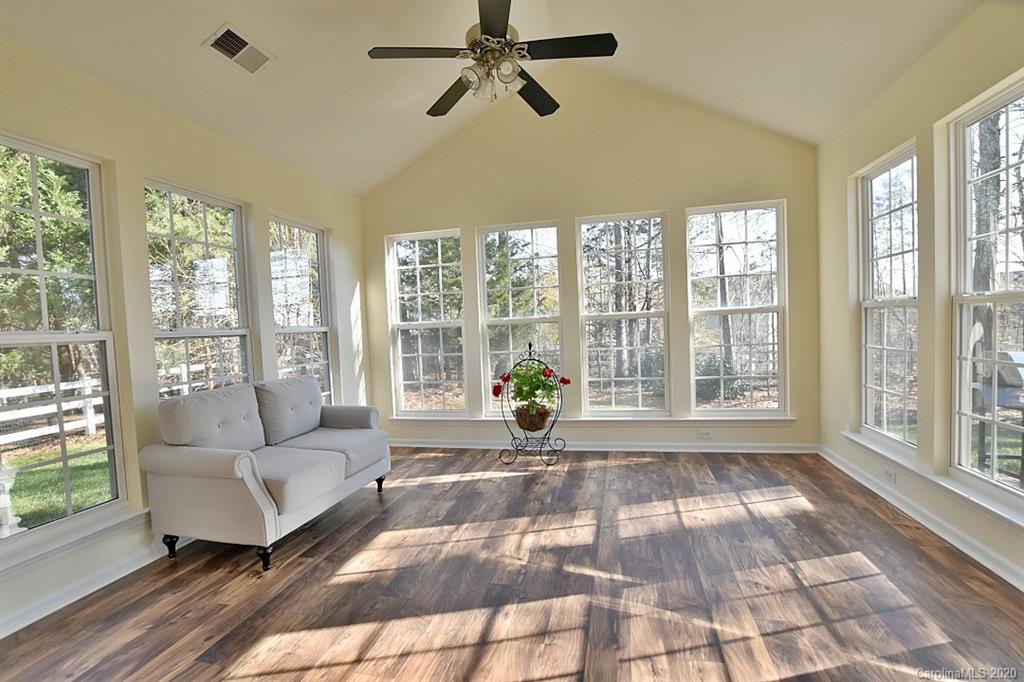 1132 Gower Street Fort Mill, SC 29708 - Photo 13 of 27 a living room with furniture and a floor to ceiling window