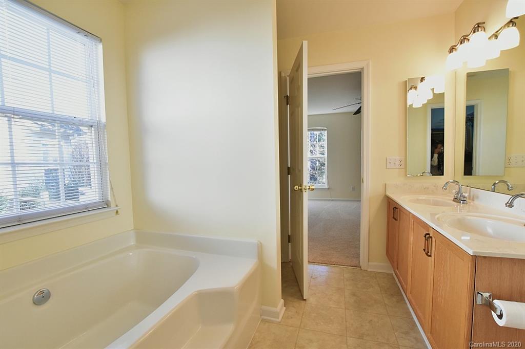 1132 Gower Street Fort Mill, SC 29708 - Photo 18 of 27 a bathroom with a tub sink and mirror